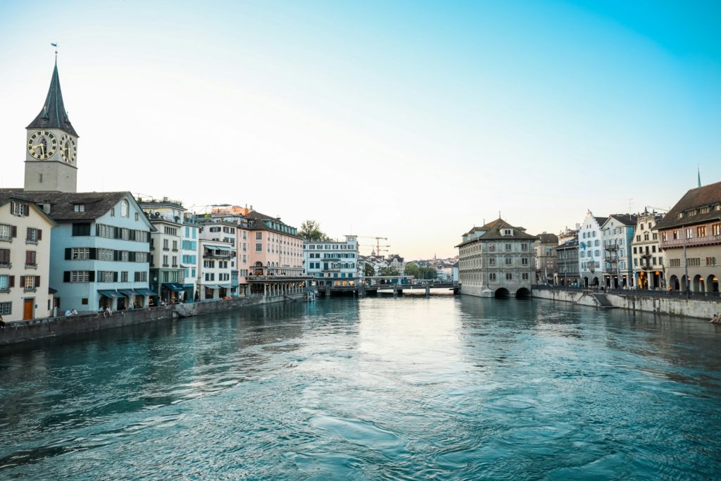 body of water between buildings under blue sky during daytime