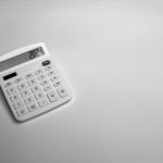 a white calculator sitting on top of a table