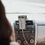 a car dashboard with a cell phone hooked up to it